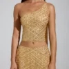 Cosette-top med asymmetrisk scarf-detalj i guld