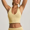 Gianna bouclé-crop-top med halterneck i gult