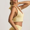 Gianna bouclé-crop-top med halterneck i gult