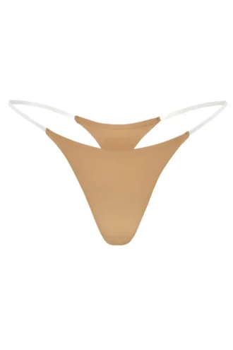 Intimates sömlös stringtrosa i karamellfärg med genomskinliga band
