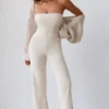 Jumpsuit i grovstickat tyg med bandeau-halsringning och utsvängda byxben i krämfärg