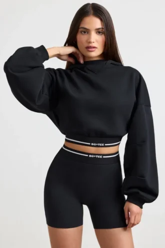 Kort hoodie i stretchig bomullsfleece i svart