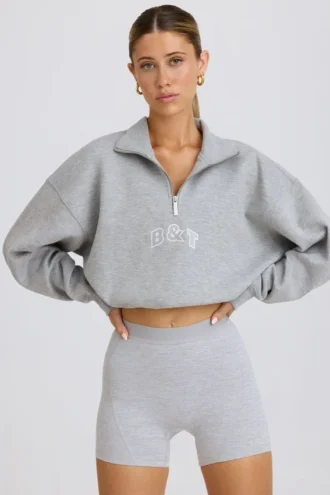 Kort sweatshirt med kvartslång dragkedja i gråmelerat