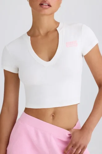 Kort T-shirt i stretchig bomullsjersey med grafiskt tryck i vitt
