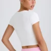 Kort T-shirt i stretchig bomullsjersey med grafiskt tryck i vitt
