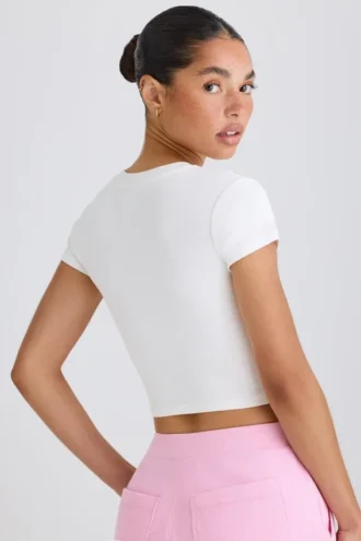 Kort T-shirt i stretchig bomullsjersey med grafiskt tryck i vitt