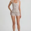 Lalita-playsuit med knappar och halterneck i ecru