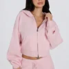 Mjuk, kort hoodie i stickat med dragkedja i ljusrosa