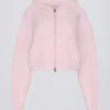 Mjuk, kort hoodie i stickat med dragkedja i ljusrosa