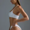 Oh Polly Badkläder: HOTFIX Edition Bandeau-bikinitopp med en axel och dekorationer i vitt