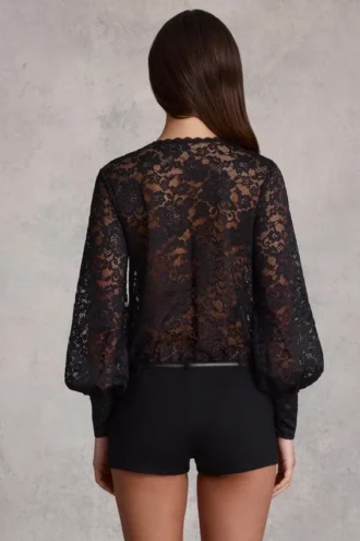 Serenya genomskinlig spets-playsuit med djup urringning och lös passform i svart