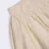 Thia minikjol med rosettdetalj i broderie anglaise i elfenben