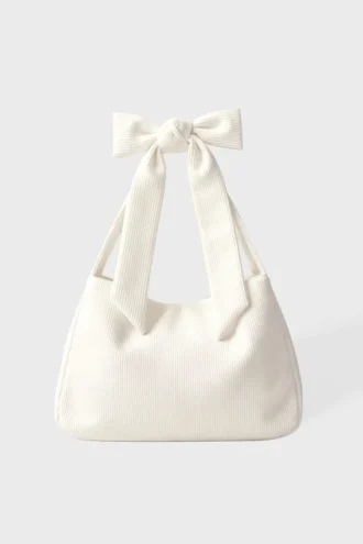 Tygväska i corduroy med rosett i färgen Ivory